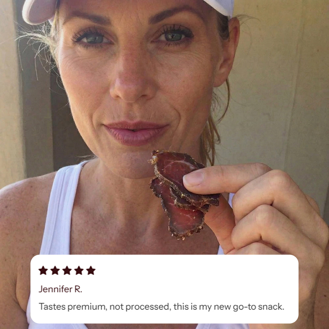 Woman holding a piece of biltong with a five-star rating overlay and review text.